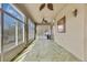 Sunroom with flagstone flooring, ceiling fans, and large windows at 9739 Asbel Estates St, Land O Lakes, FL 34638