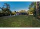 Spacious backyard with a screened patio and lush greenery at 9800 Mendel Dr, New Port Richey, FL 34654