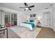 Bright bedroom with a view to the backyard, a ceiling fan and plenty of closet space at 9800 Mendel Dr, New Port Richey, FL 34654