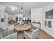 Charming round dining table with kitchen and living room views at 9800 Mendel Dr, New Port Richey, FL 34654