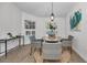 Charming dining area with a round table and wicker chairs at 9800 Mendel Dr, New Port Richey, FL 34654
