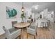 Bright dining area with a round table, wicker chairs, and kitchen access at 9800 Mendel Dr, New Port Richey, FL 34654
