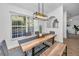 Spacious dining area with a long wooden table and access to the kitchen and living room at 9800 Mendel Dr, New Port Richey, FL 34654