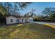 House exterior showcasing a large yard and driveway at 9800 Mendel Dr, New Port Richey, FL 34654