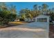 Exterior view of the house, showcasing the front yard and driveway at 9800 Mendel Dr, New Port Richey, FL 34654