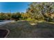 Front yard with mature trees and grassy area at 9800 Mendel Dr, New Port Richey, FL 34654