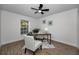 Bright home office features wood desk, comfy chairs, and wood-look floors at 9800 Mendel Dr, New Port Richey, FL 34654
