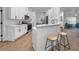 Modern kitchen with white cabinets, stainless steel appliances, and breakfast bar at 9800 Mendel Dr, New Port Richey, FL 34654
