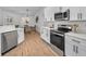 Modern kitchen with stainless steel appliances and white cabinets at 9800 Mendel Dr, New Port Richey, FL 34654
