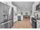 Modern kitchen with white cabinets and stainless steel appliances at 9800 Mendel Dr, New Port Richey, FL 34654