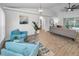 Living room with vaulted ceiling, hardwood floors, and access to pool at 9800 Mendel Dr, New Port Richey, FL 34654