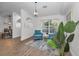 Bright living room with hardwood floors, comfy seating, and large windows at 9800 Mendel Dr, New Port Richey, FL 34654