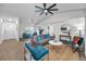 Open living space with hardwood floors and a ceiling fan at 9800 Mendel Dr, New Port Richey, FL 34654