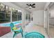 Relaxing pool enclosure with tiled floor, seating, and access to refreshing pool at 9800 Mendel Dr, New Port Richey, FL 34654