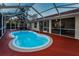 Enjoy this refreshing kidney-shaped pool with screened enclosure at 9800 Mendel Dr, New Port Richey, FL 34654