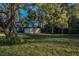 Spacious backyard with detached garage and mature trees at 9800 Mendel Dr, New Port Richey, FL 34654