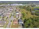 Aerial view of Mirabella community, showcasing homes, landscape, and nearby school at 10703 Aldo Moro Dr, Wimauma, FL 33598
