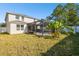 Large backyard with screened patio and tropical plants at 10703 Aldo Moro Dr, Wimauma, FL 33598