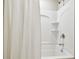 Clean bathroom with white tub, shower, and curtain at 10703 Aldo Moro Dr, Wimauma, FL 33598