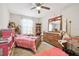 bedroom with pink bedding and a mirrored dresser at 10703 Aldo Moro Dr, Wimauma, FL 33598