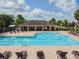 Resort-style community pool with lounge chairs at 10703 Aldo Moro Dr, Wimauma, FL 33598