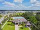 Community pool with clubhouse and surrounding landscape at 10703 Aldo Moro Dr, Wimauma, FL 33598
