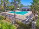 Community pool with lounge chairs and surrounding landscape at 10703 Aldo Moro Dr, Wimauma, FL 33598