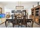 Bright dining room with a large glass top table and chandelier at 10703 Aldo Moro Dr, Wimauma, FL 33598