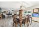Spacious dining area with hardwood floors and a view into the living room at 10703 Aldo Moro Dr, Wimauma, FL 33598