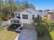 Two-story house with attached garage and landscaping at 10703 Aldo Moro Dr, Wimauma, FL 33598