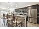 Modern kitchen with stainless steel appliances and granite countertops at 10703 Aldo Moro Dr, Wimauma, FL 33598