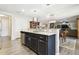 Spacious kitchen with island, granite countertops, and stainless steel appliances at 10703 Aldo Moro Dr, Wimauma, FL 33598