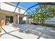 Large screened patio with hot tub and lush landscaping at 10703 Aldo Moro Dr, Wimauma, FL 33598