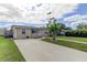 Tan single-story house with a driveway and palm tree at 1142 56Th N Ave, St Petersburg, FL 33703