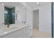 Double vanity bathroom with a large mirror and light wood floors at 13750 Park Blvd # 8, Seminole, FL 33776