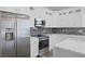 Modern kitchen with stainless steel appliances and white cabinetry at 13750 Park Blvd # 8, Seminole, FL 33776