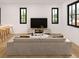 Spacious living room featuring a comfortable sofa and large TV, perfect for relaxation at 13750 Park Blvd # 8, Seminole, FL 33776