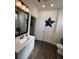 Guest bathroom with a single vanity, toilet, and wood-look flooring at 1449 Kaffir Lily Ct, Trinity, FL 34655
