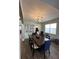 Dining room with large table, blue chairs, and a chandelier at 1449 Kaffir Lily Ct, Trinity, FL 34655
