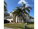 Charming two-story home with palm trees and landscaping in front yard at 1449 Kaffir Lily Ct, Trinity, FL 34655