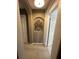Hallway with carpeted floors and decorative niche at 1449 Kaffir Lily Ct, Trinity, FL 34655