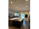 Modern kitchen with large island, stainless steel appliances, and wood-look floors at 1449 Kaffir Lily Ct, Trinity, FL 34655
