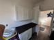 Laundry room with white cabinets, dark countertop, and wood-look flooring at 1449 Kaffir Lily Ct, Trinity, FL 34655