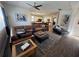 Inviting living room with brown sectional sofa, wood floors, and view of the kitchen at 1449 Kaffir Lily Ct, Trinity, FL 34655