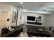 Living area with sleek entertainment center, dark wood floors, and modern decor at 1449 Kaffir Lily Ct, Trinity, FL 34655