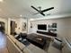 Spacious living room with comfortable seating, dark wood floors, and entertainment center at 1449 Kaffir Lily Ct, Trinity, FL 34655