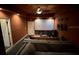 Home theater with projector screen, couch, and guitars on the wall at 1449 Kaffir Lily Ct, Trinity, FL 34655