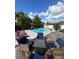 Backyard oasis featuring a refreshing pool, patio furniture, and lush landscaping at 1449 Kaffir Lily Ct, Trinity, FL 34655