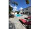 Inviting pool area with lounge chairs, paved patio, and a two-story home in the background at 1449 Kaffir Lily Ct, Trinity, FL 34655