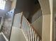 Elegant staircase with white spindles and wooden handrail at 1449 Kaffir Lily Ct, Trinity, FL 34655